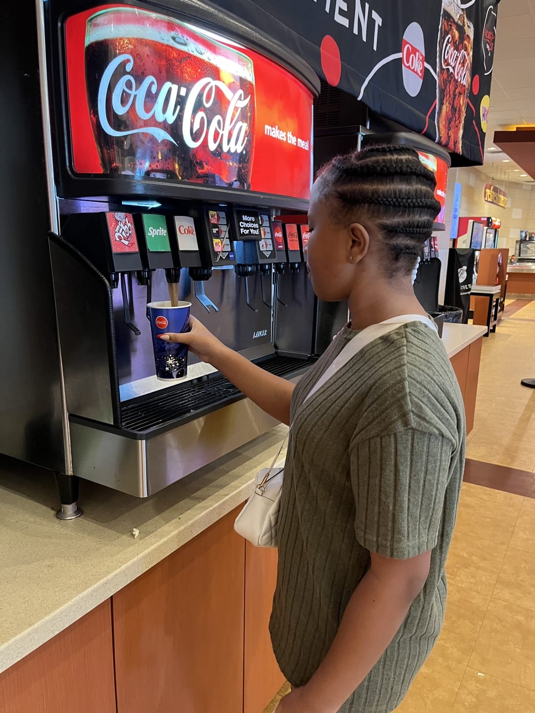 happy girl taking the beverage for the movie