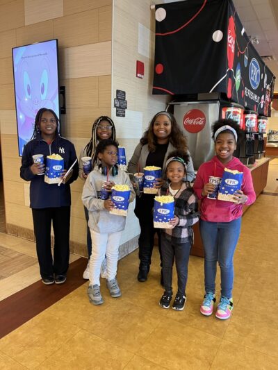 girls smiling at the cinema with pop corn