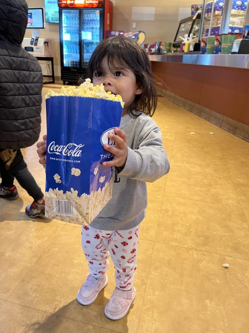 little girl with pop corn