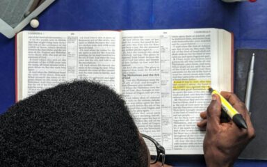 Student reading a bible