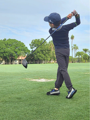 William playing golf